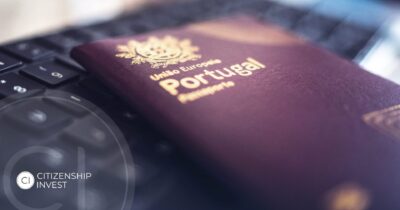 Portuguese passport placed on a laptop keyboard, symbolizing fast-track EU citizenship for global investors
