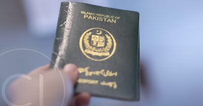 Close-up of Pakistani passport held in hand, symbolizing mobility potential and global investment access