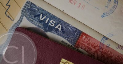 Close-up of a US visa stamp in a passport with immigration entry marks